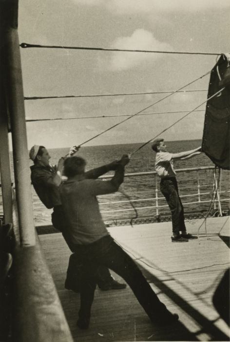 Sailors securing deck awning at sea, 1930s